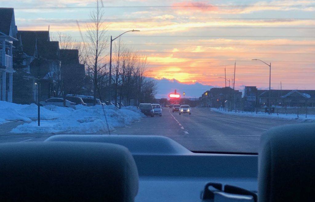 sunset out of the back window of car